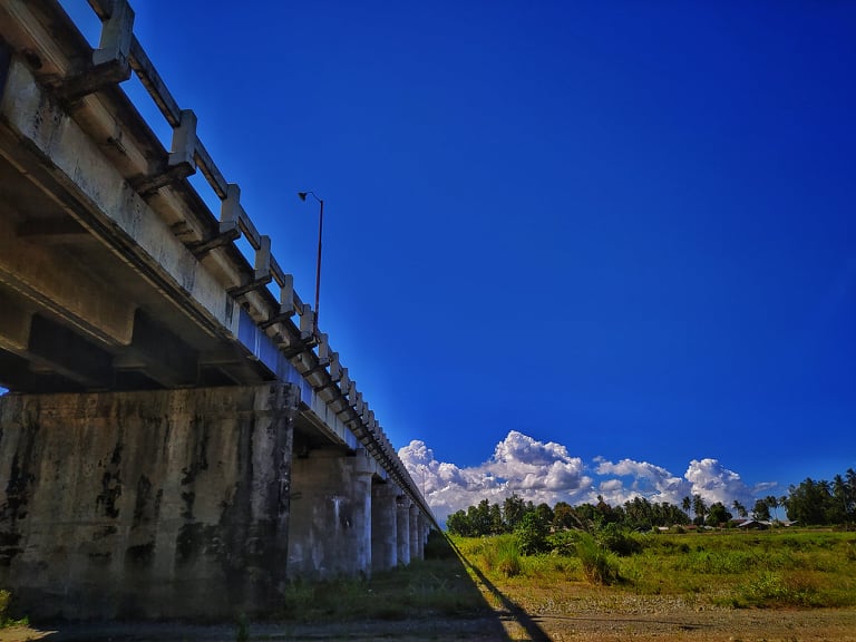 <b class="font-bara"><i class="bi bi-geo-fill h4"></i> CARAC-AN BRIDGE</b> <br/>The longest bridge in Mindanao measuring almost 1 kilometer long. Located at the heart of Brgy. San Juan, Madrid, Surigao del Sur.